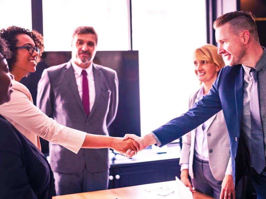 man and woman networking at an MBA conference, networking as an MBA