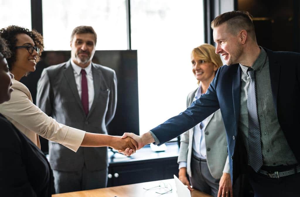 man and woman networking at an MBA conference, networking as an MBA